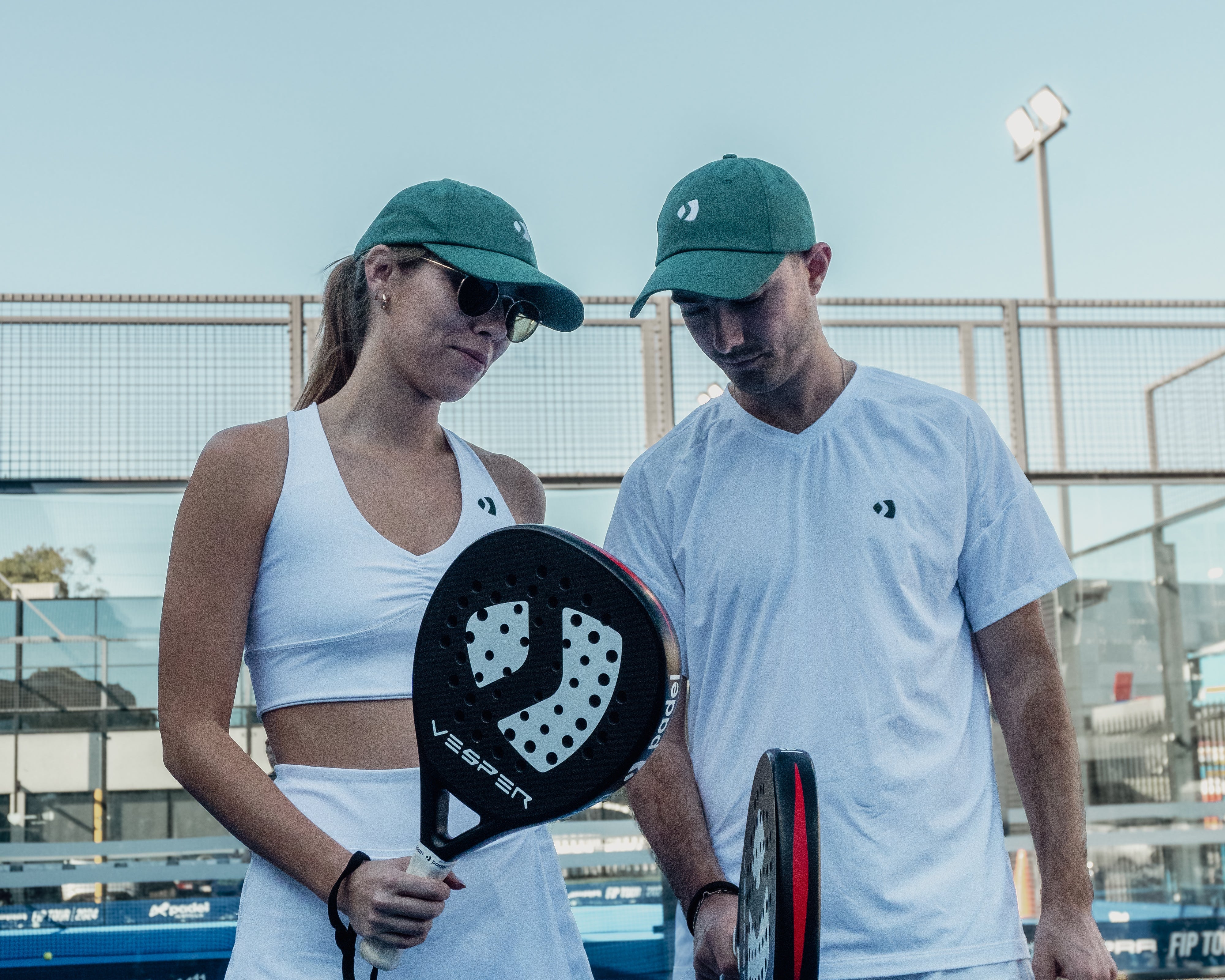 Two Paddle Players. Wearing padel clothing and padle racquets. Two premium padel rackets.