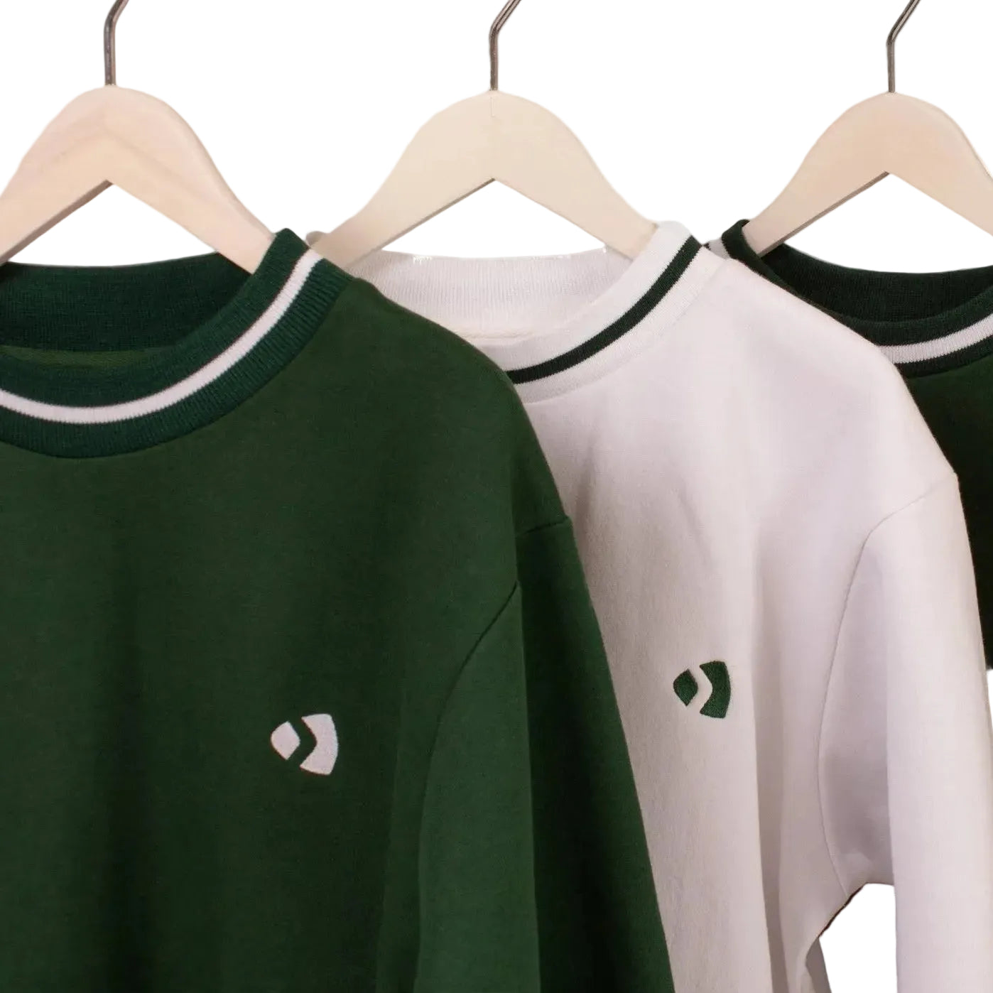 A two-tone jumper sweatshirt in green and white, with ribbed trims, displayed on a hanger.