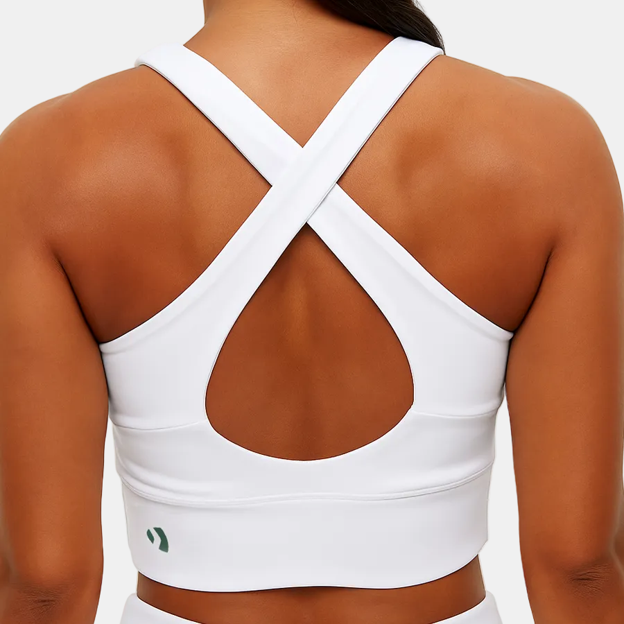 Women's Padel Top. A white padel top. Sporty padel clothing. A close-up of performance sports wear. Active lifestyle. Padel court use. 